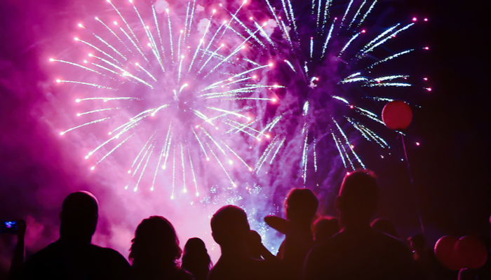 A crowd of people watching a fireworks display