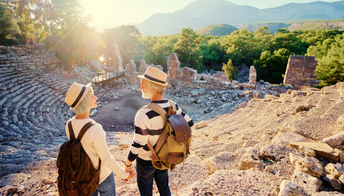 A mature couple visiting an ancient amphitheatre.