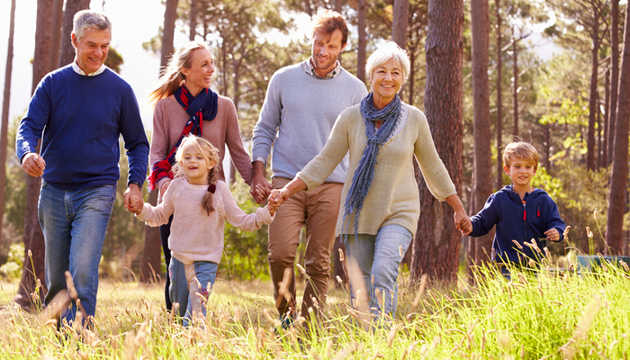 A multi-generational family walking through the countryside.