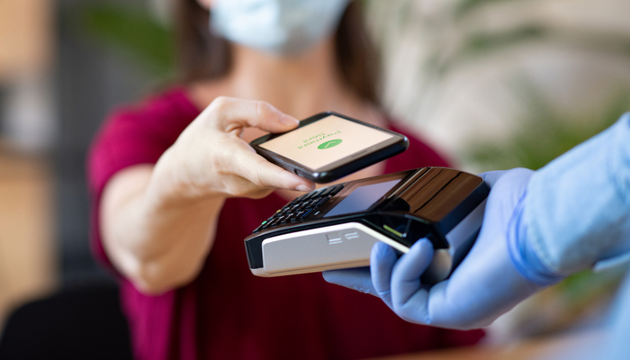 A woman using contactless payment.