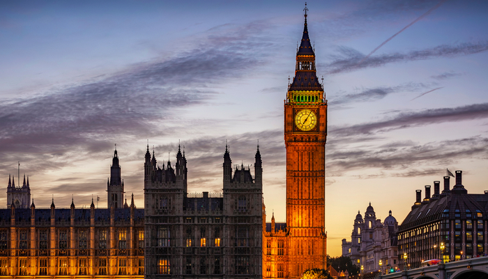 An external image of the Palace of Westminster in the evening