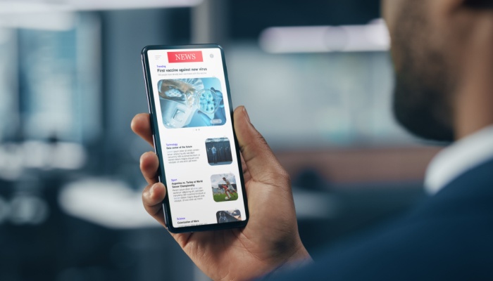 A man checking the news on his smartphone.
