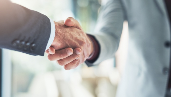 Two people shaking hands.