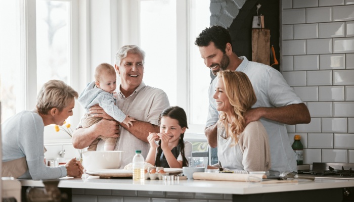 Three generations of family cooking in the kitchen