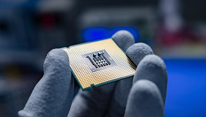 A hand holding a CPU.