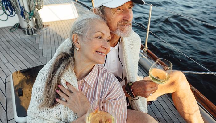 A couple sitting on a yacht deck.