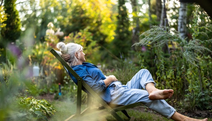 A woman relaxing in a garden.