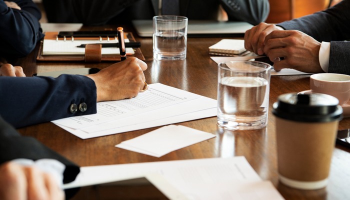 People sitting around a table for a company meeting.